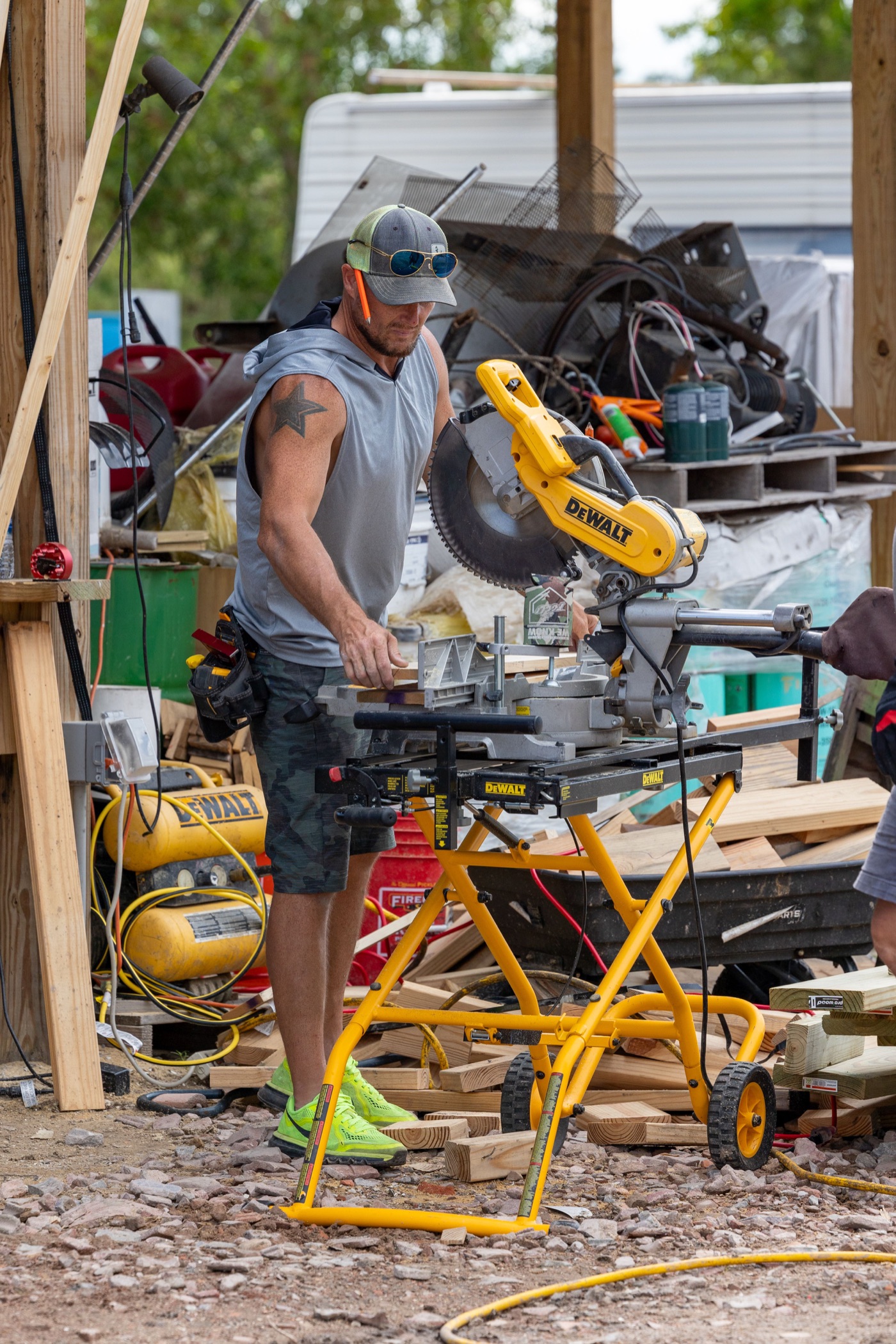 A person working with timber at a ranch construction project