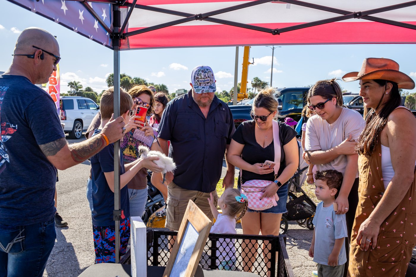 Families gathered around the ranch’s animal enclosure at Touch A Truck